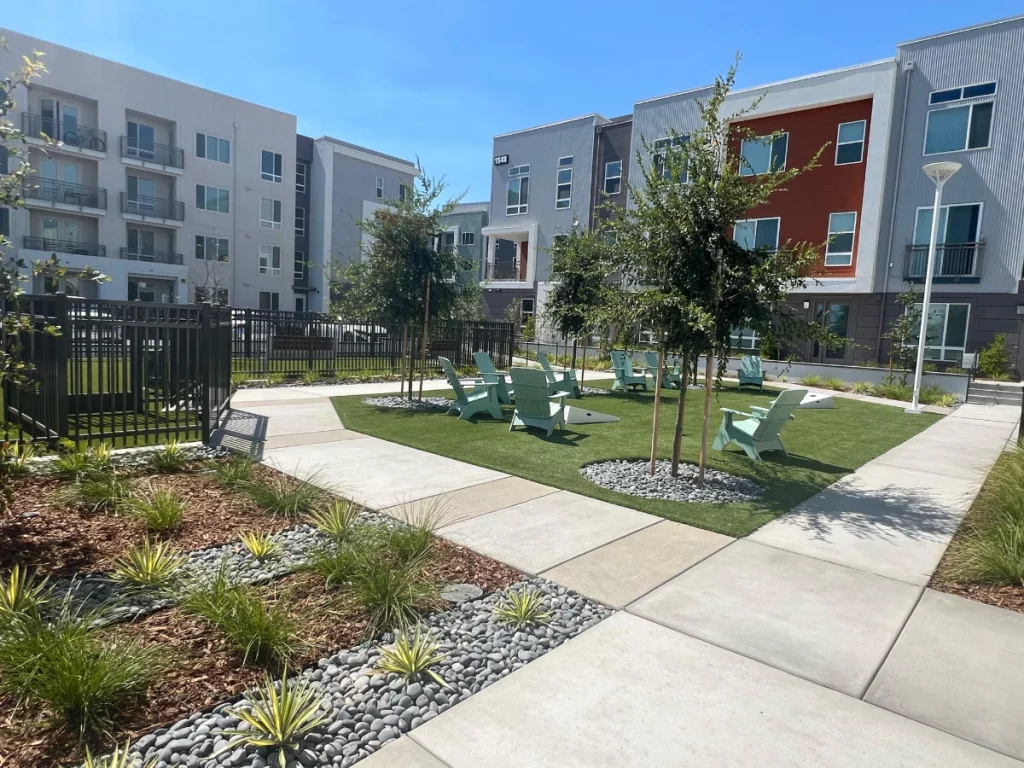 building exterior with central landscaping between apartments