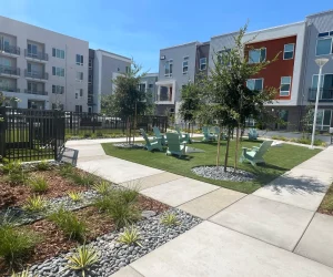 building exterior with central landscaping between apartments