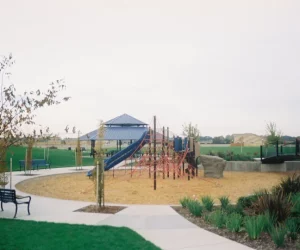 outdoor playground with climbing structure and slides